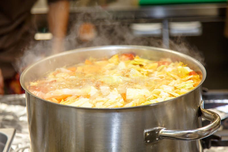 The Soup is Cooked in a Large Pot in the Kitchen in the Restaurant