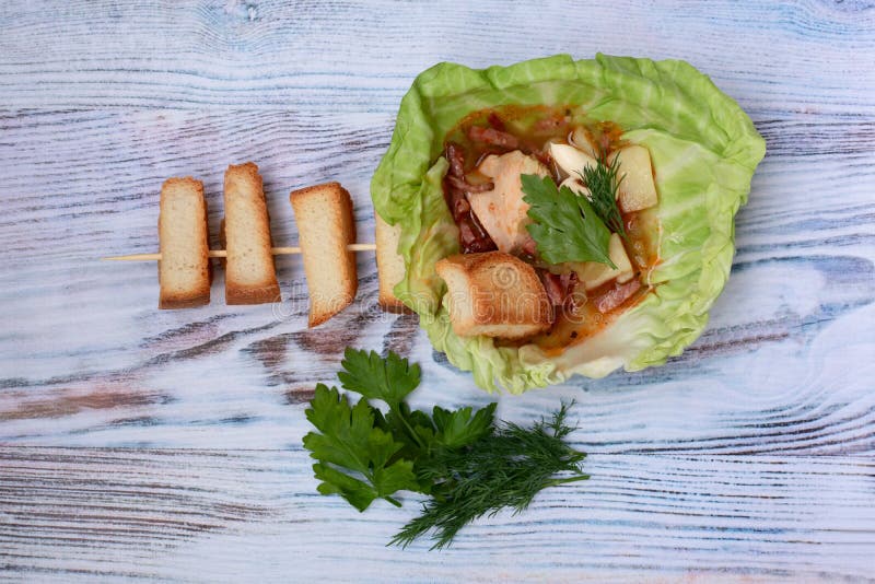 Soup Cooked in Meat Broth with Fresh Herbs and Croutons in a Plate of