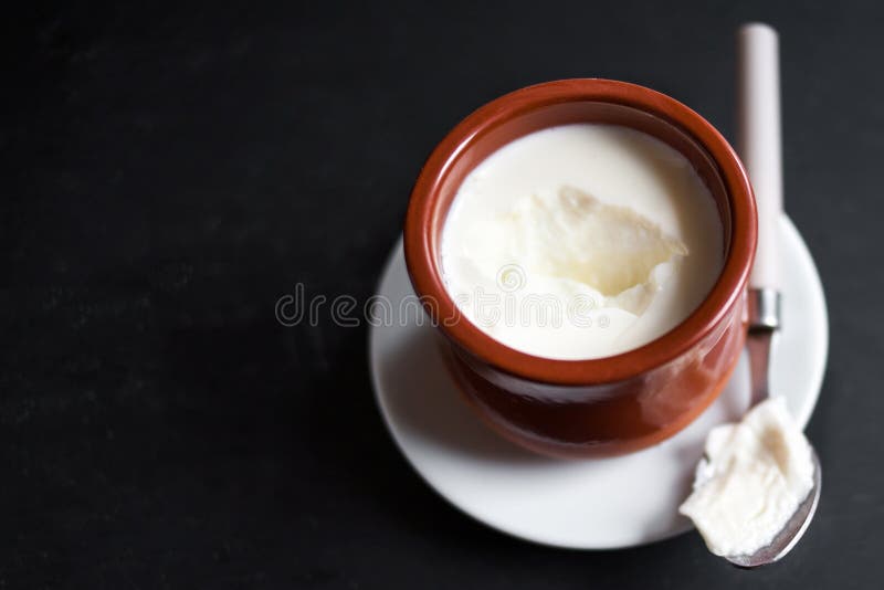 Sour Cream Or Natural Cottage Cheese Curd In Clay Pot On Dark