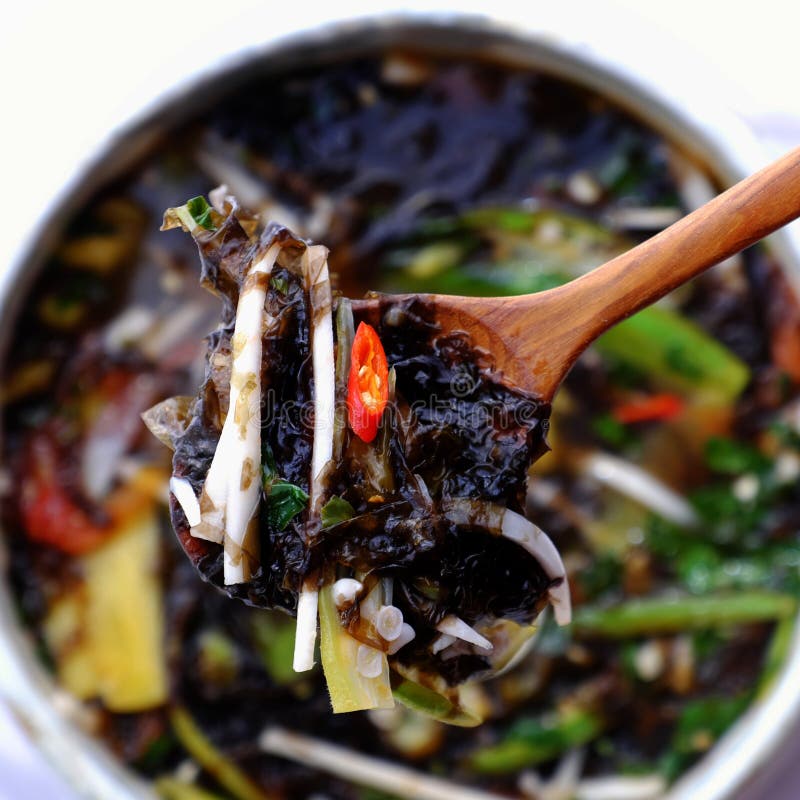 Sour vegetables soup bowl for vegan meal from nutrition ingredient food as seaweed, bamboo shoot, tomato, okra, pine apple stock images Sour vegetables soup bowl for vegan meal from nutrition ingredient food as seaweed, bamboo shoot, tomato, okra, pine apple stock images