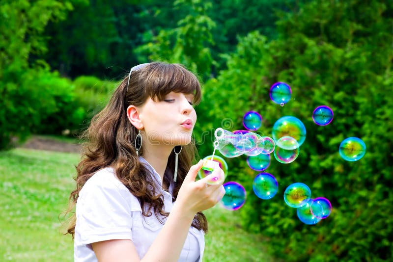 Smile teen with soap bubbles in vivid green spring forest park. Smile teen with soap bubbles in vivid green spring forest park