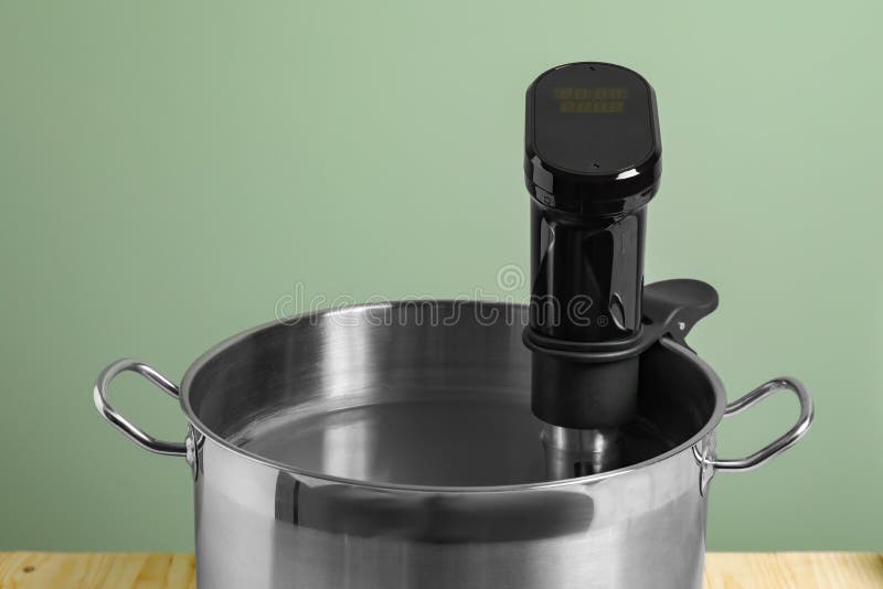 Sous Vide Cooker in Pot on Table, Closeup. Thermal Immersion Circulator