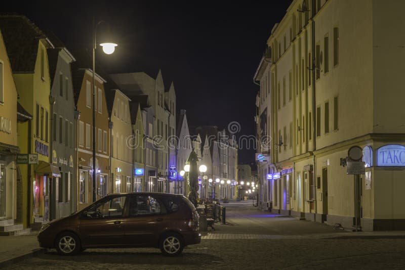 Warszawska Street in the city of Zagan at night.