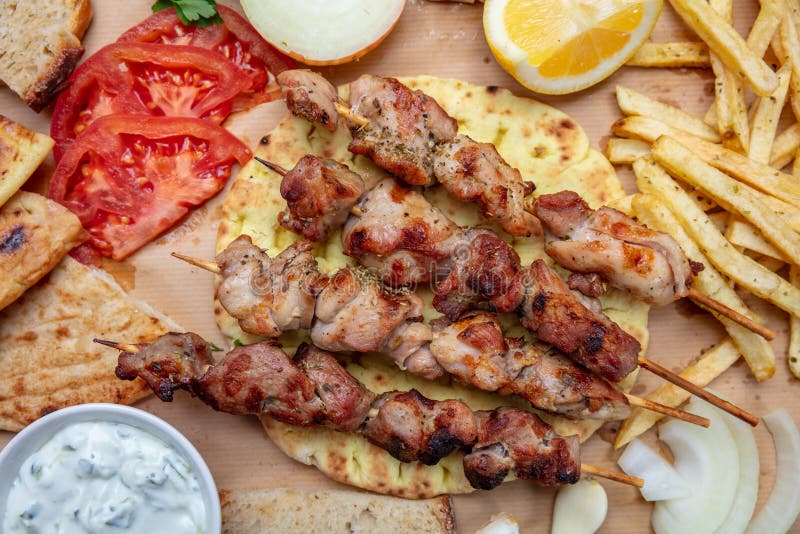 Souvlaki, meat skewers, traditional greek turkish meat food on pita bread, tzatziki sauce and potatoes royalty free stock photos Souvlaki, meat skewers, traditional greek turkish meat food on pita bread, tzatziki sauce and potatoes royalty free stock photos