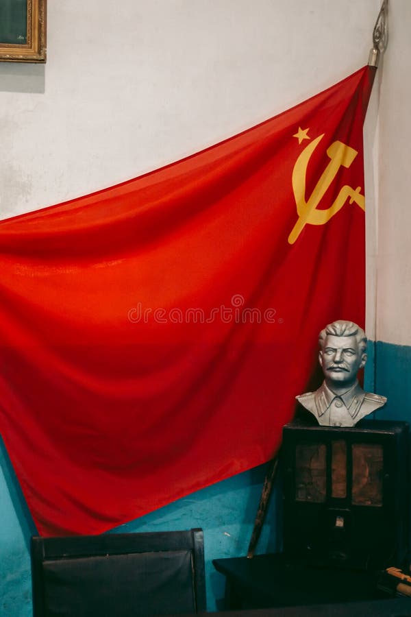 Soviet Red Flag with a Sickle and a Hammer and a Bust of Lenin in the
