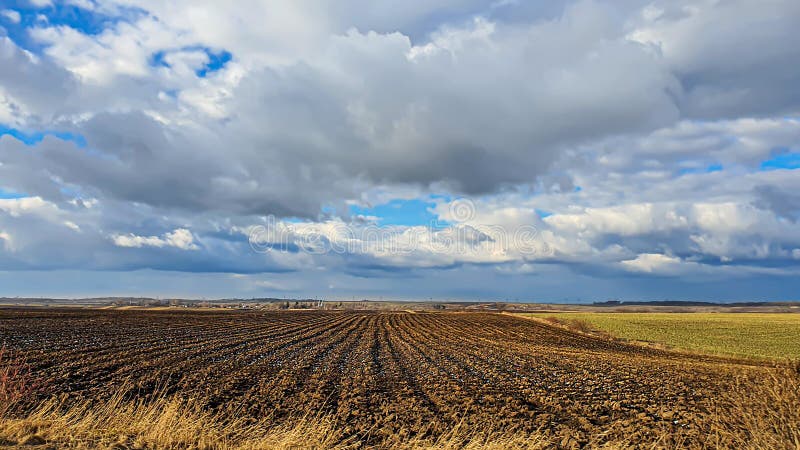 Sowing time in Ukraine during the war. Preparing fields for sowing grain. Blue sky, plowed land. terror.