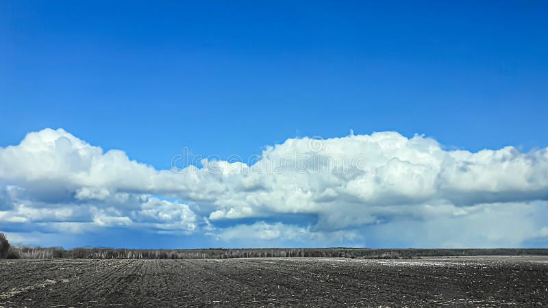 Sowing time in Ukraine during the war. Preparing fields for sowing grain. Blue sky, plowed land. terror.