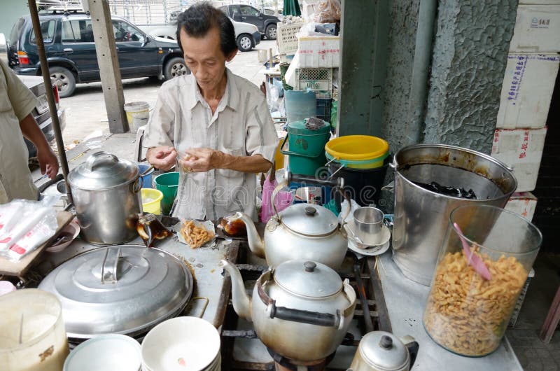 BANGKOK, THAILAND - October 28 : Unidentified man preparation bean curd jelly dessert for sell on October 28, 2013 in Bangkok, Thailand. BANGKOK, THAILAND - October 28 : Unidentified man preparation bean curd jelly dessert for sell on October 28, 2013 in Bangkok, Thailand.