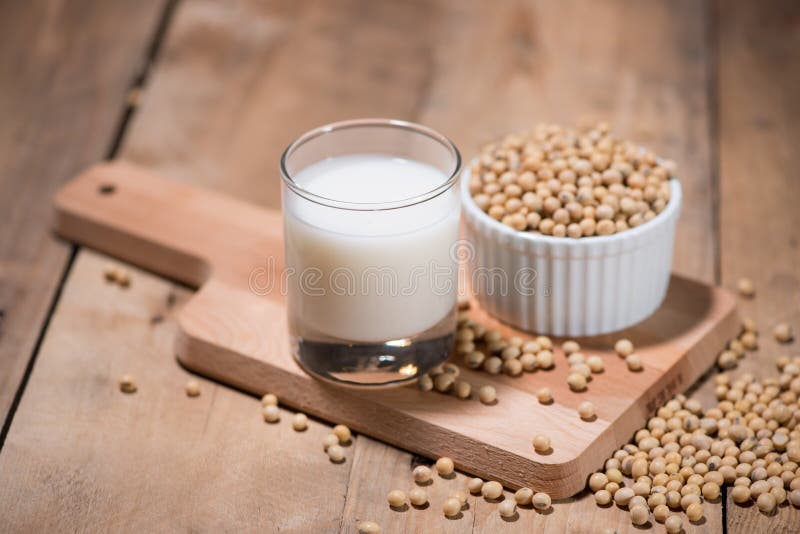 Soy Milk or Soya Milk and Soy Beans in Spoon on Wooden Table. Stock