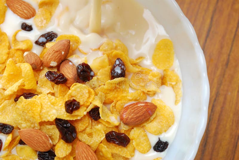 Soya milk pouring into healthy cereal stock image