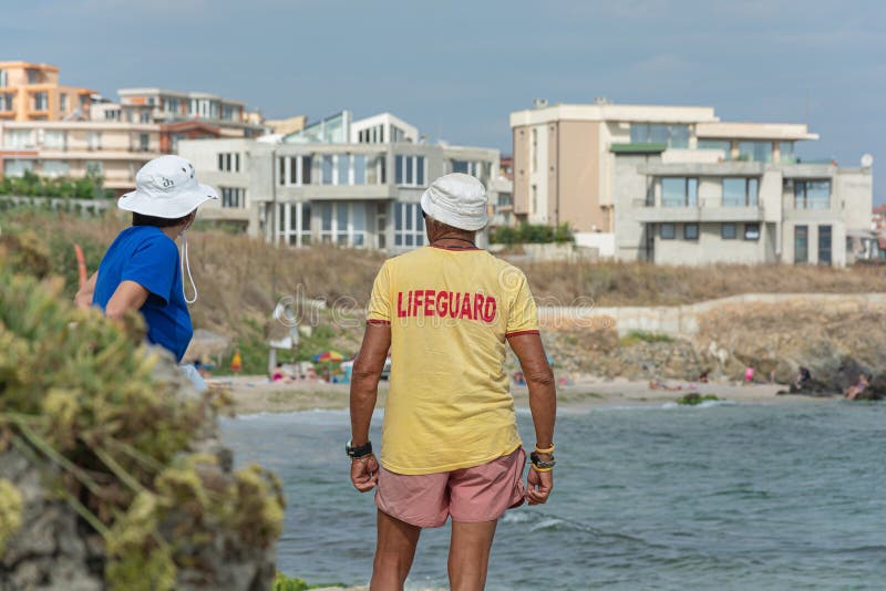 Sozopol, Bulgaria - 09/06/2018: a Man in a t-shirt with the inscription lifeguard. Stock photo. Sozopol, Bulgaria - 09/06/2018: a Man in a t-shirt with the inscription lifeguard. Stock photo