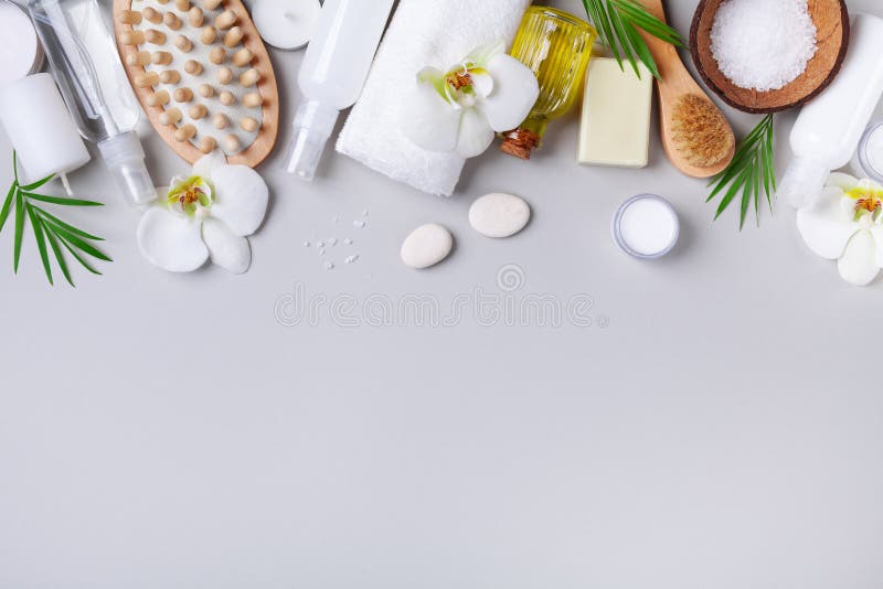 Spa, aromatherapy, beauty treatment and wellness background with massage brush, towel, orchid flowers and cosmetic products. stock photo Spa, aromatherapy, beauty treatment and wellness background with massage brush, towel, orchid flowers and cosmetic products. stock photo