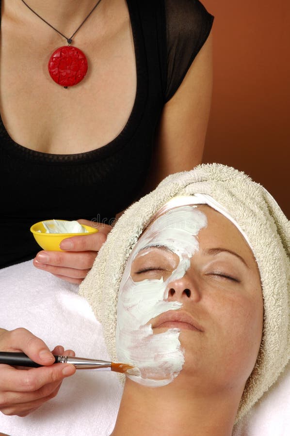 Organic facial mask application by esthetician at day spa salon. Organic facial mask application by esthetician at day spa salon