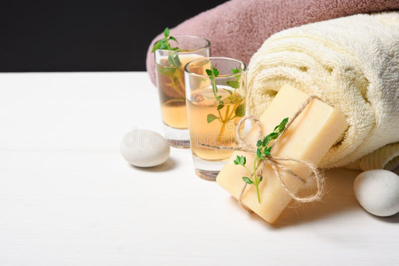 Spa concept setting: oil, towel, soap, stone on white stock photo