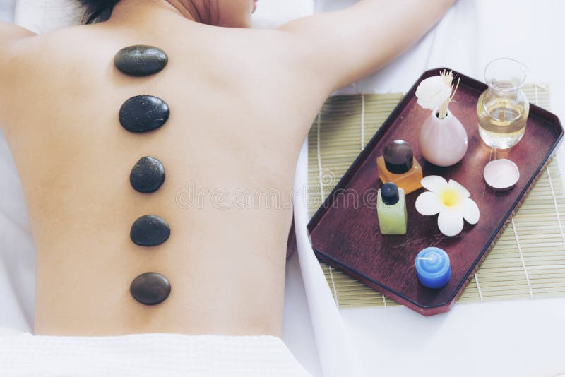 Spa Concept.Stone Massage on Back Relaxation for Beautiful Woman Stock