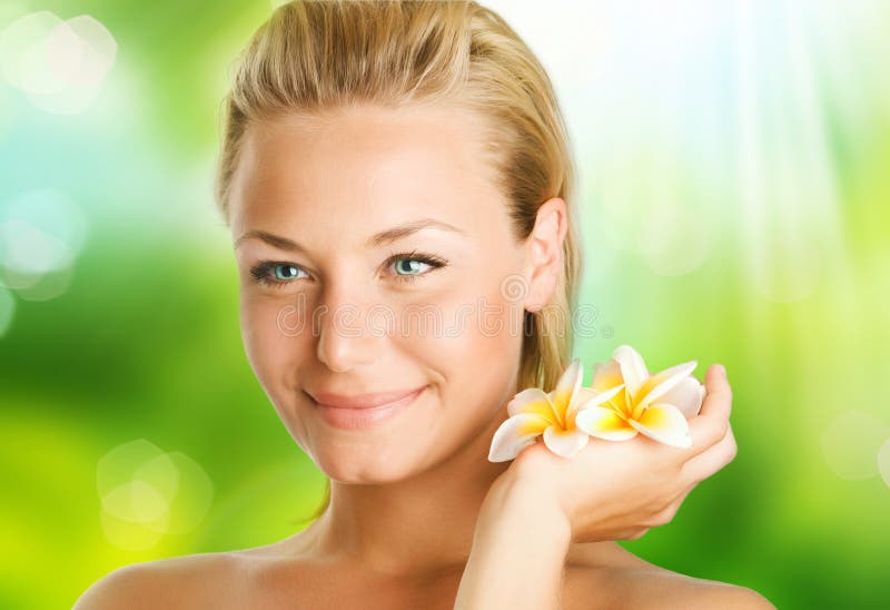 Beautiful Spa Girl with Frangipani flowers over nature background