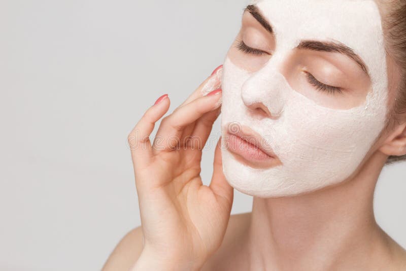 Spa girl applying facial mask