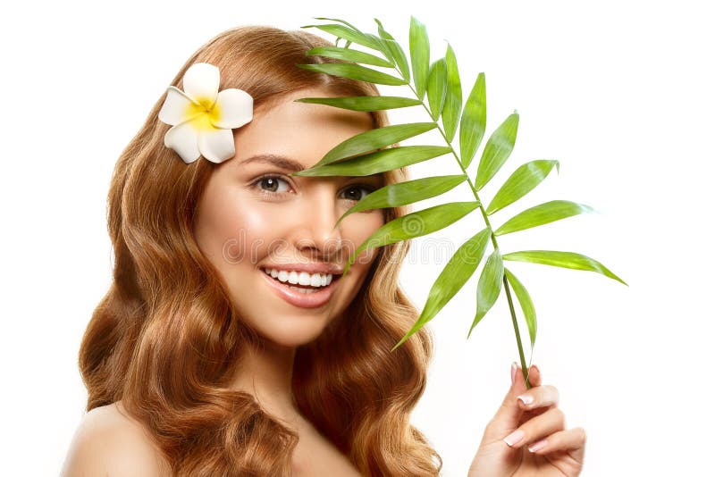 Spa girl. beauty Young Woman with Clean Fresh Skin with tropical leaves. Facial treatment. Model with Expressive facial expression