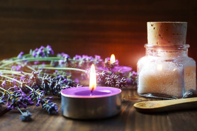 Spa massage setting with lavender flowers, scented aroma candles and cosmetic salt on wooden background royalty free stock images Spa massage setting with lavender flowers, scented aroma candles and cosmetic salt on wooden background royalty free stock images