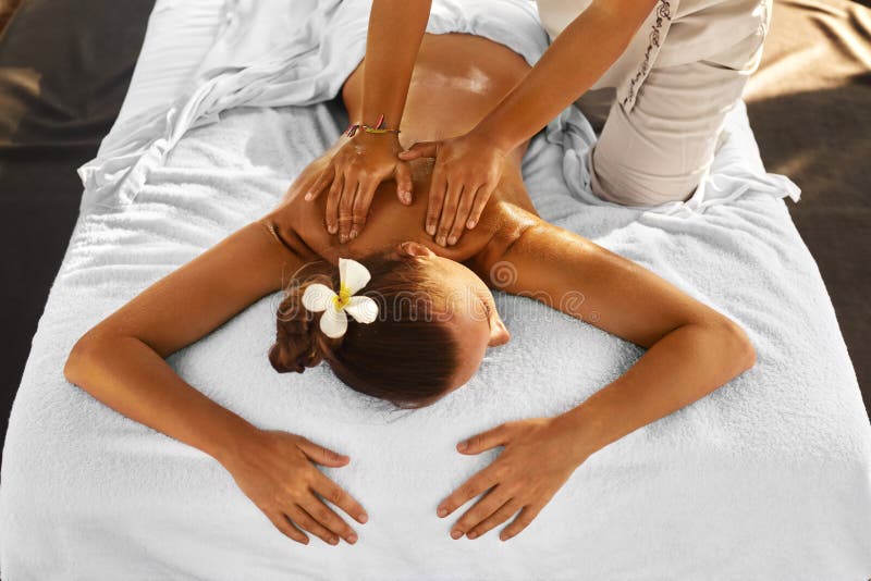 Spa Massage. Woman Relaxing, Enjoying Back Massage. Body Care