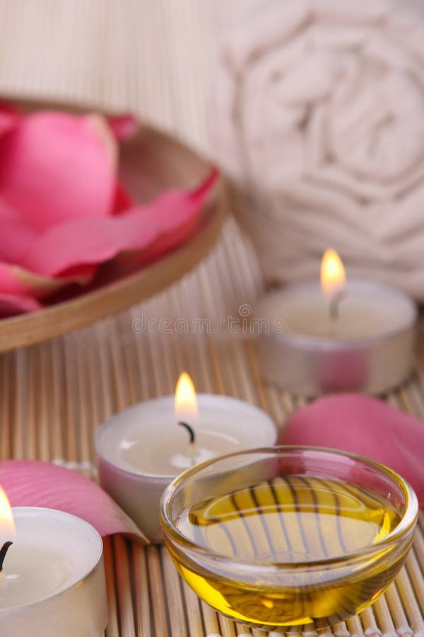 Spa products with rose petals, oil, towel