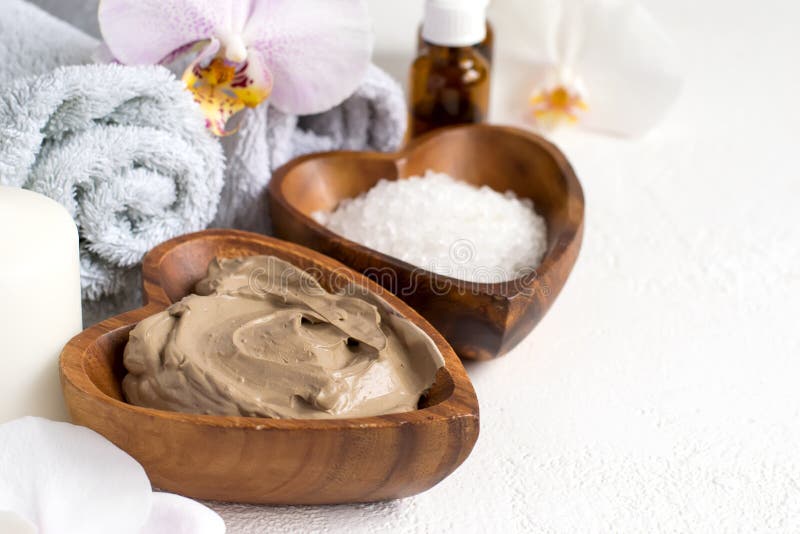 Spa setting with cosmetic clay mask for body and face, Towel and Essential oil