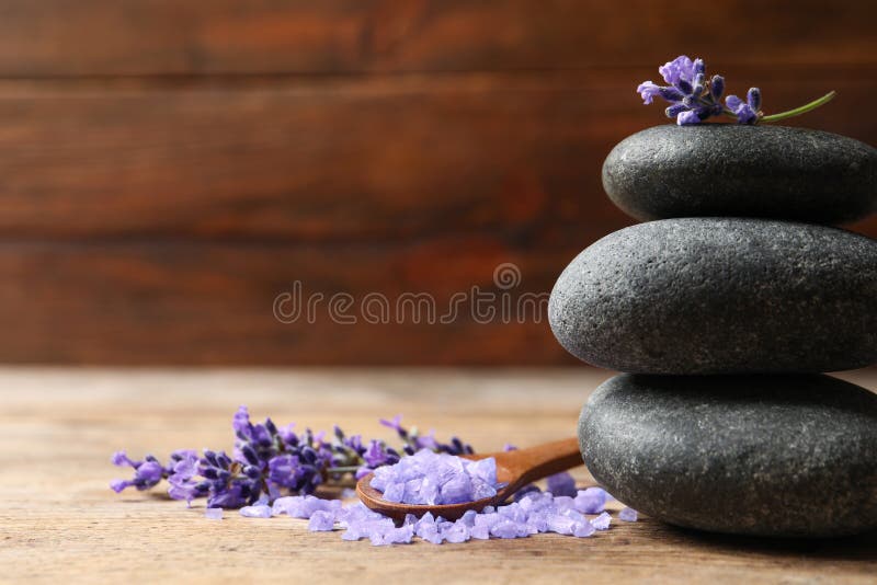 Spa stones, natural cosmetic bath salt and lavender flowers on wooden table royalty free stock photos Spa stones, natural cosmetic bath salt and lavender flowers on wooden table royalty free stock photos