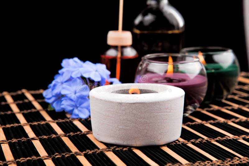 Spa theme with candles and flowers on black background