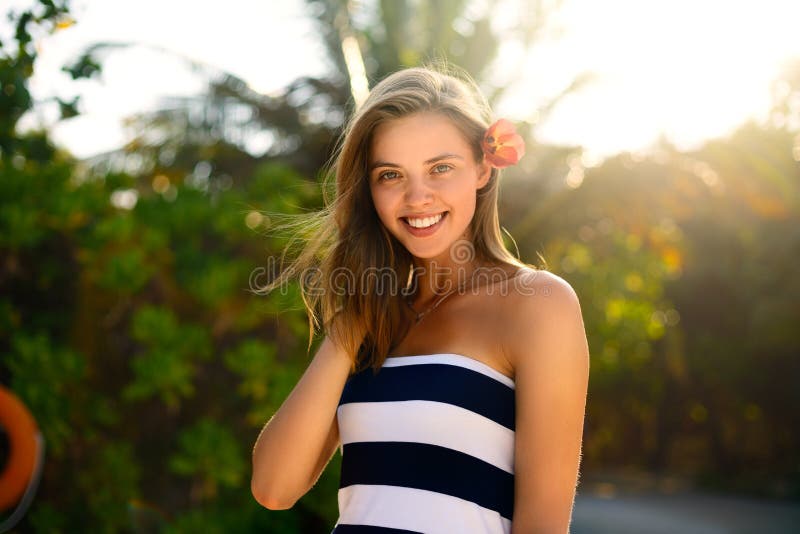 Spa wellness beach beauty woman relaxing andlooking at camera on beach. Beautiful serene and peaceful young female model