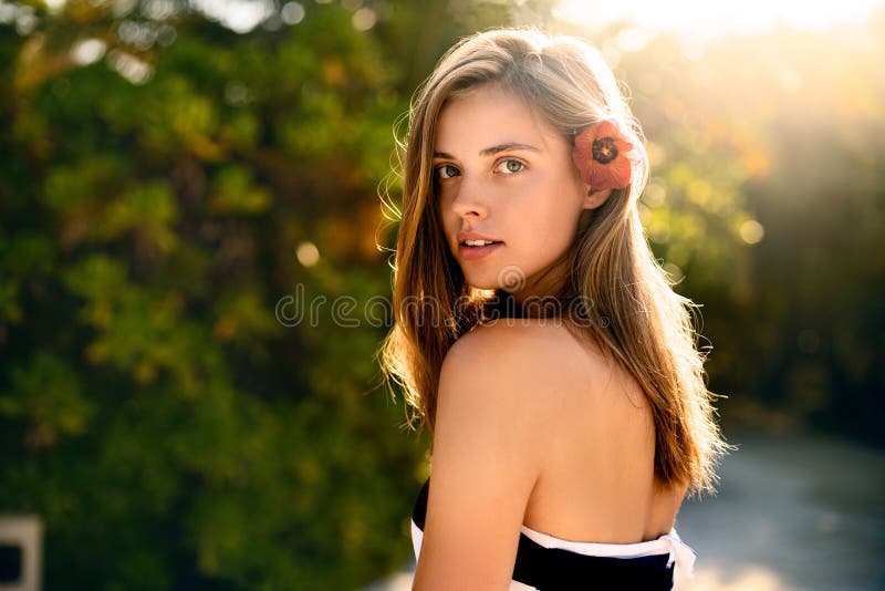 Spa wellness beach beauty woman relaxing andlooking at camera on beach. Beautiful serene and peaceful young female model