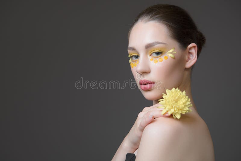 Spa young woman. Flowers on her face. The concept of skin and body care. Perfect skin health stock photo Spa young woman. Flowers on her face. The concept of skin and body care. Perfect skin health stock photo