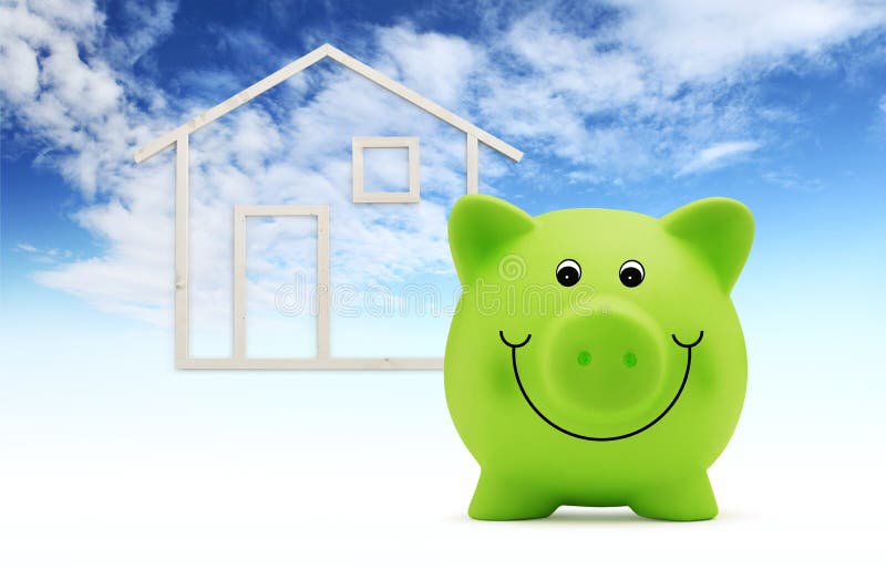 Green piggy bank with wood house shape isolated on blue sky background, green building and energy save concept. Green piggy bank with wood house shape isolated on blue sky background, green building and energy save concept