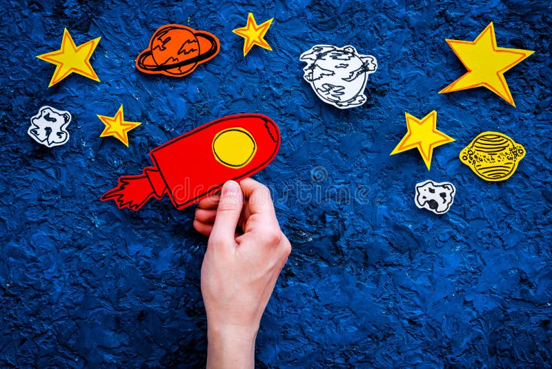 Space tourism concept. Hand hold drawn rocket or spaceship near stars on blue background top view copy space royalty free stock photography Space tourism concept. Hand hold drawn rocket or spaceship near stars on blue background top view copy space royalty free stock photography