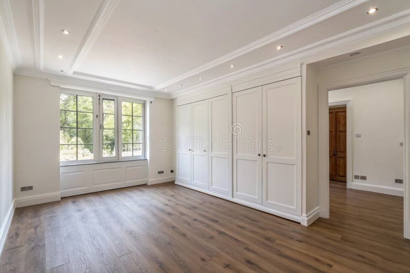 Spacious bedroom with white walls and wardrobe royalty free illustration