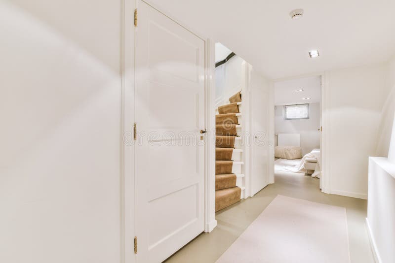 A spacious bright corridor leading inside the apartment stock photography