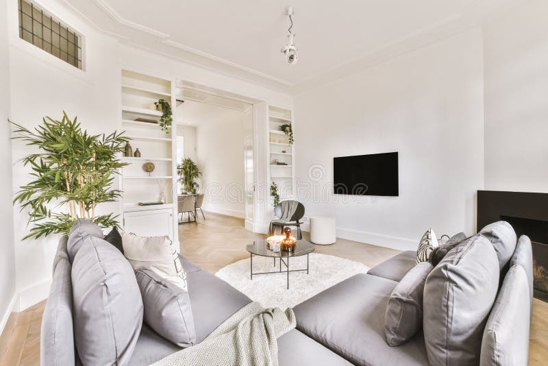 Spacious, bright living room with two small sofas stock image