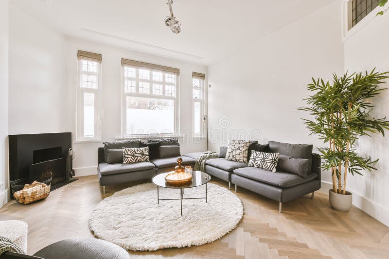 Spacious, bright living room with two small sofas stock image