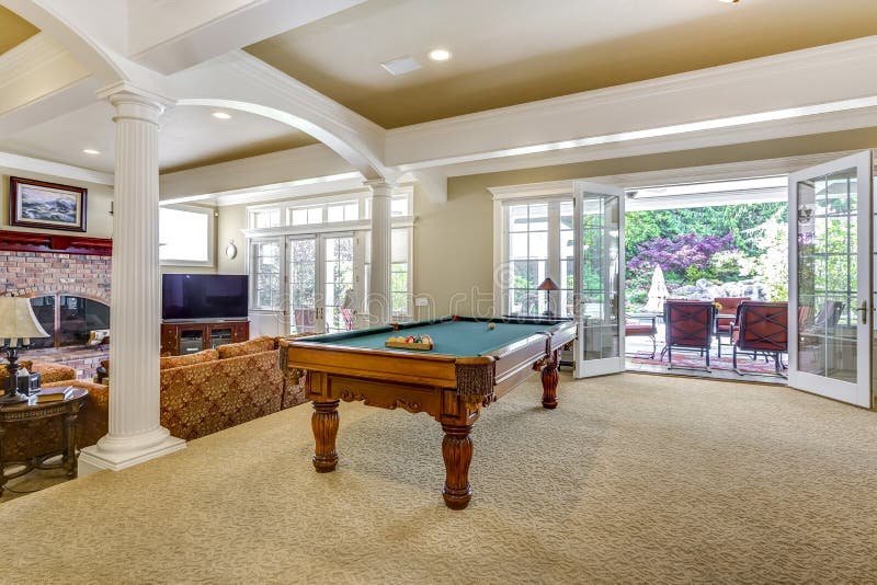 Light brown game room with billiard table