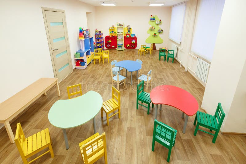 Spacious Light Pink Colored Game Room with Tables for Classes in the