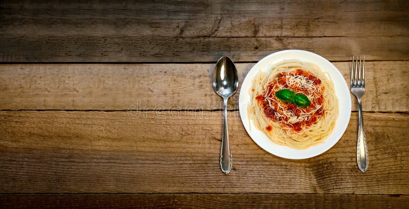 Spagettipasta med tomatsås, ost och basilika på trätabellen traditionell matitalienare royaltyfri bild Spagettipasta med tomatsås, ost och basilika på trätabellen traditionell matitalienare royaltyfri bild