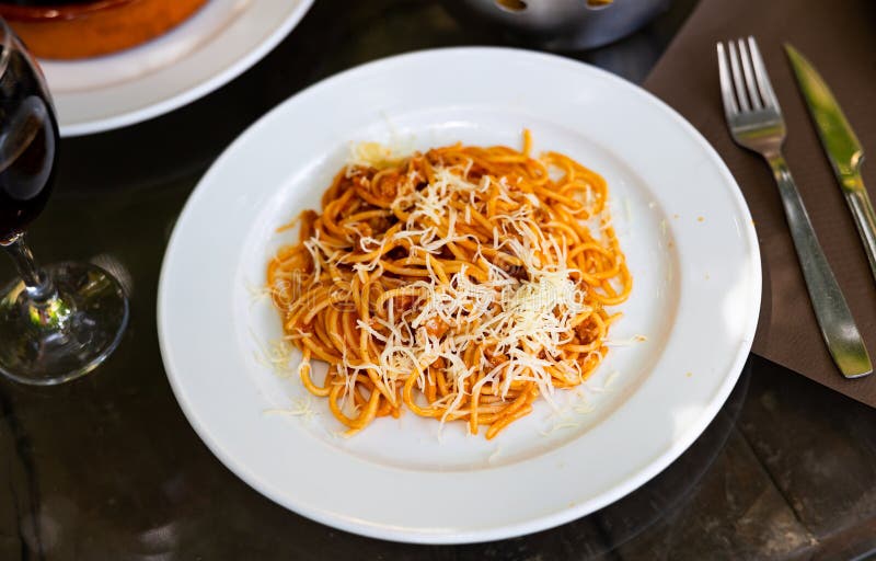 Spaghetti bolognese with cheese served on platter stock photography