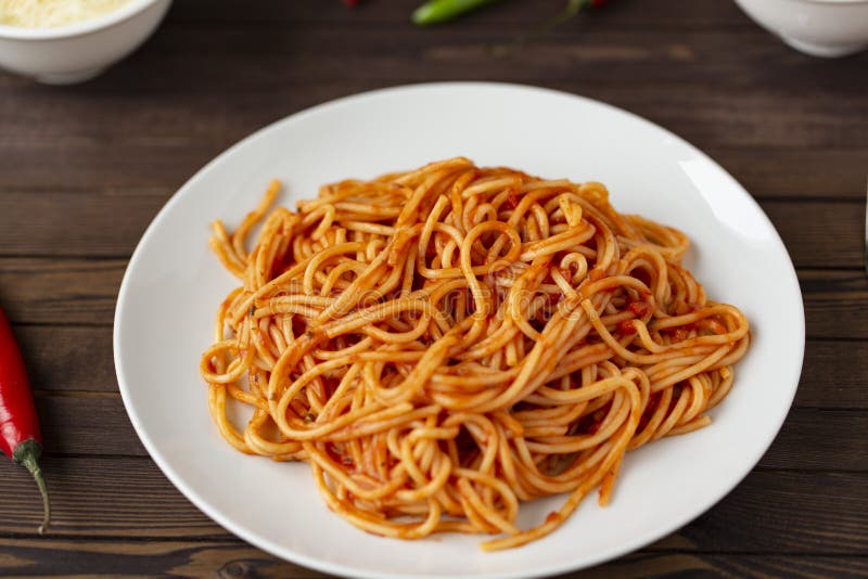 Spaghetti bolognese pasta with tomato sauce and minced meat, grated parmesan cheese and fresh basil