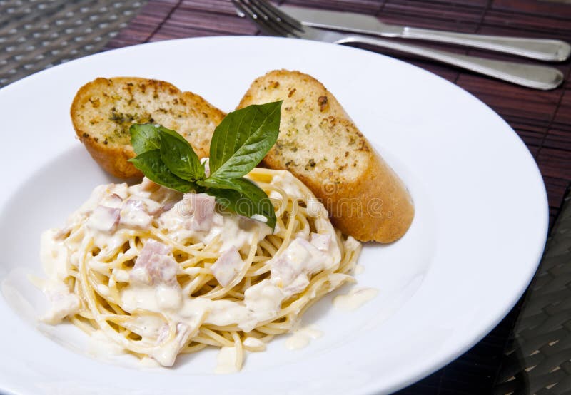 Spaghetti and Garlic Bread stock photo. Image of black 2578360
