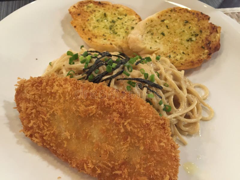 Spaghetti with fried fish stock image. Image of spaghetti 70109831
