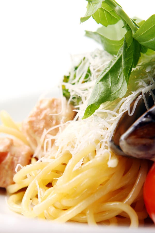 Spaghetti and meat with cheese basil and mussels stock images