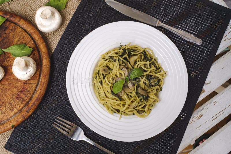 Spaghetti Pasta with Spinach, Mushrooms and Pesto Sauce Stock Image