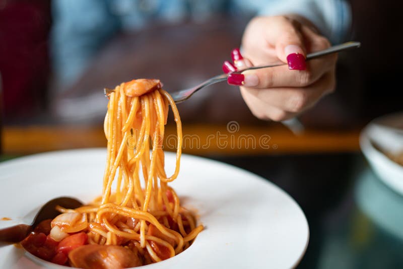 Spaghetti and sausages with sauce.