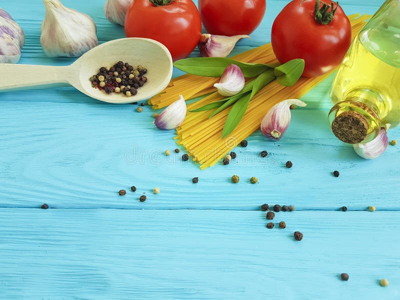 Spaghetti, tomato, garlic, cheese border kitchen on a wooden background cuisine menu dinner kitchen italian