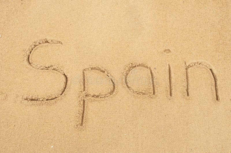 A picture of the word Spain drawn in the sand