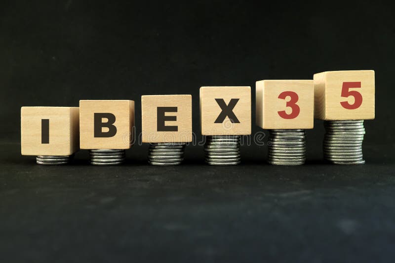 Spain stock market economy growth and recovery concept. IBEX 35 index in wooden blocks with increasing stack of coins in black bac